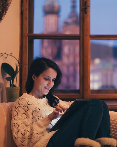 Woman using her tablet at home