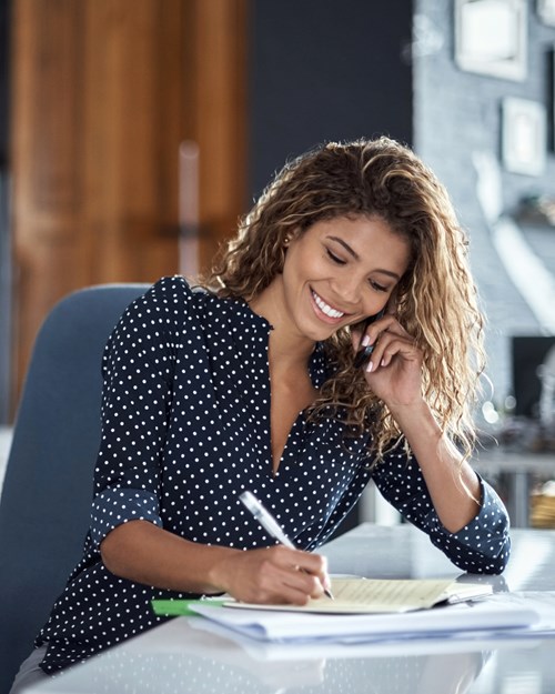 Woman taking notes from a business call