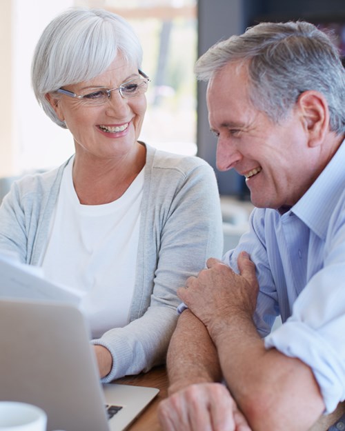 Elderly couple looking through finances