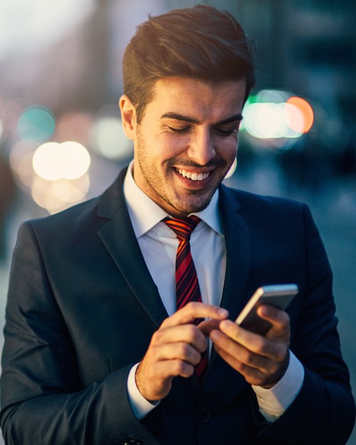 Man in suit looking at mobile phone