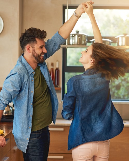 Young couple dancing in kitchen