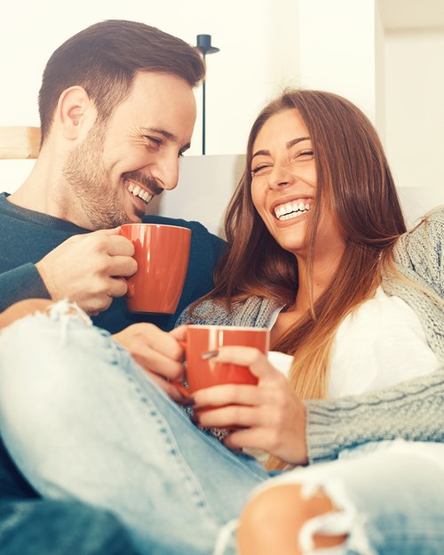 couple laughing with a coffee