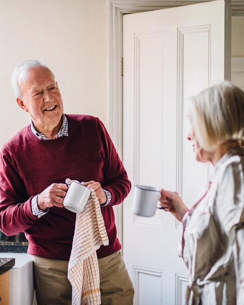 Retired couple discussing mortgages in kitchen