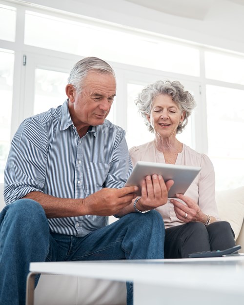 Older couple looking at mortgages on ipad