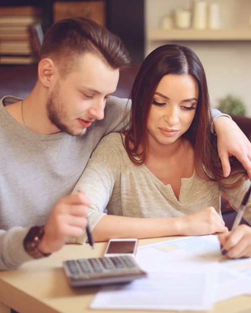 Couple with calculator and paperwork