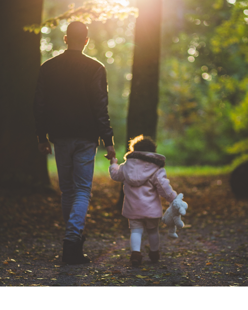 Father and daughter walking in the woods