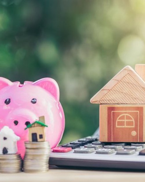 piggy bank and house with calculator 